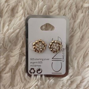 Gold flower shaped earrings with diamond centers